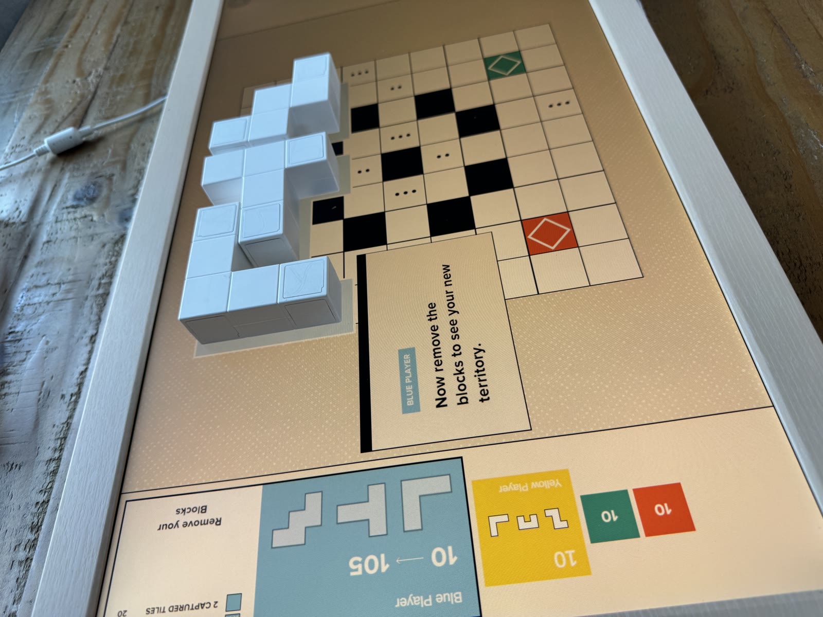 Blue physical blocks awaiting removal after the first confirmed turn.